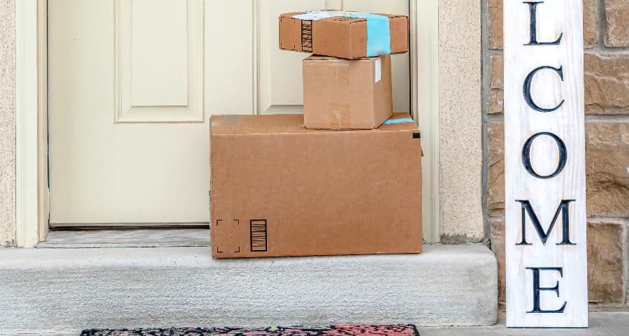 Deliveries on the front porch of a house with a welcome sign in Tucson